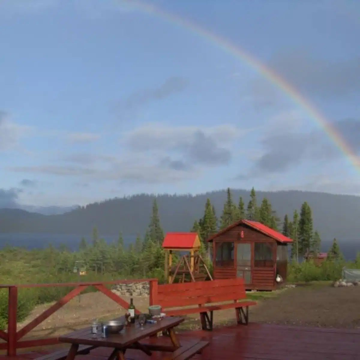 View from the inn's deck overlooking the outdoor facilities under a rainbow.