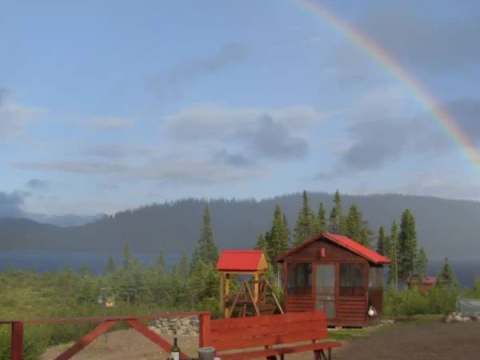 View from the inn's deck overlooking the outdoor facilities under a rainbow.