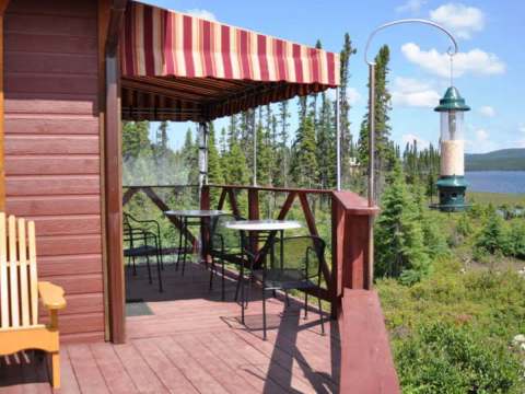 Enjoy the forest view from the furnished deck of our inn.