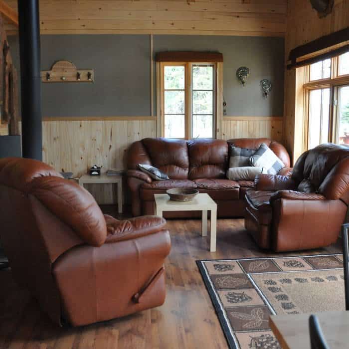 The cottage living room includes leather armchairs and a fireplace for your comfort.