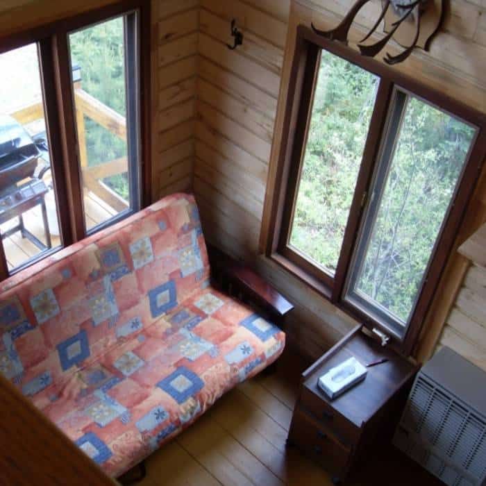 A comfortable lounge area with a sofa bed in Chalet Point 6.