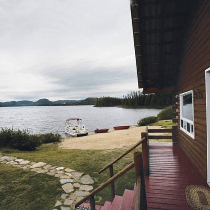 View of the lake from the cabin deck overlooking the beach and boats.