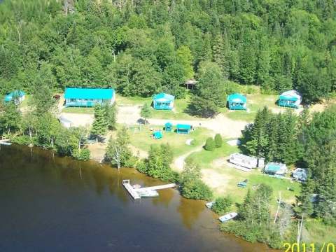 Aerial view of all cabins and outfitter facilities by the lake.