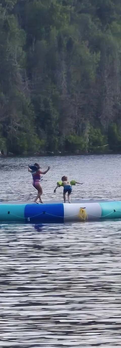 Water trampoline for family swimming on the lake at Pourvoirie Raoul Lavoie, Charlevoix, Quebec