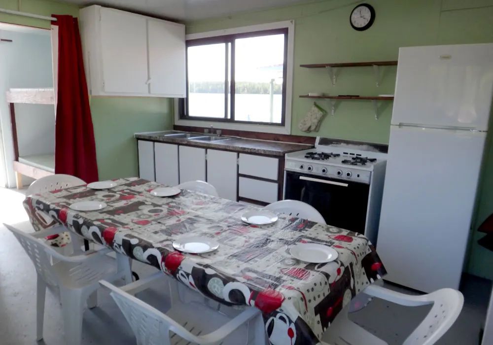 View of the kitchen and dining area inside the houseboat.