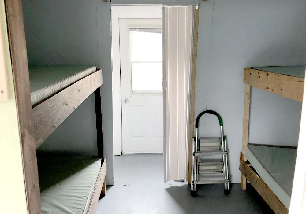 This houseboat bedroom is equipped with wooden bunk beds.