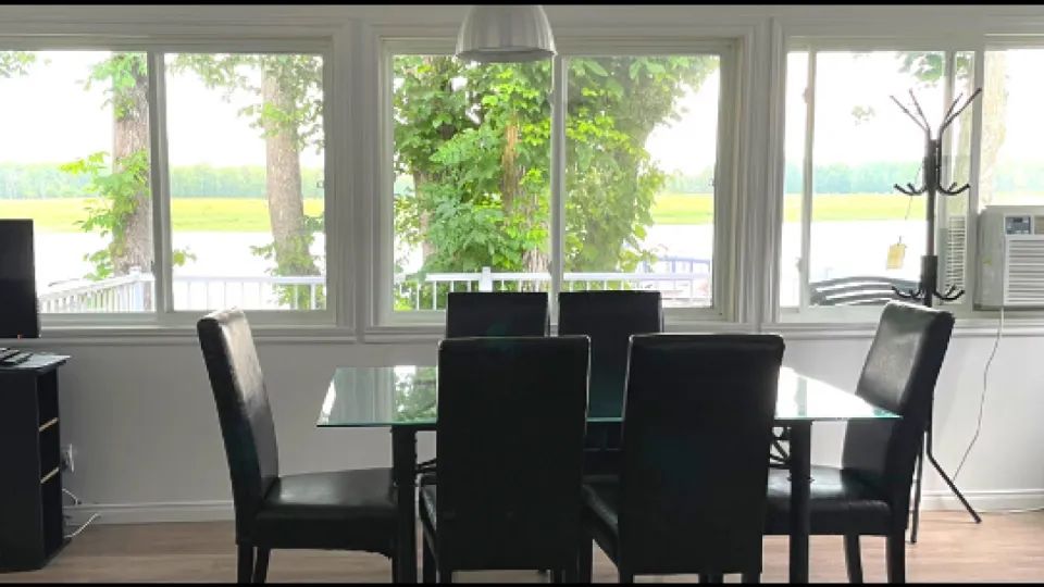 The dining room offers a direct view of the lake through large, bright windows.