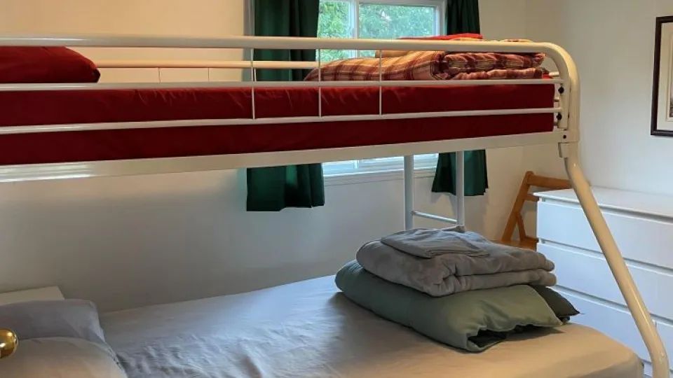 This bedroom is equipped with bunk beds and clean bedding.