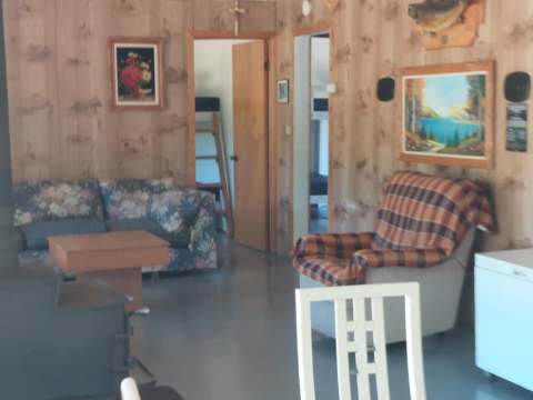 Cozy living area with lounge and dining space inside the L'Aigle cabin.