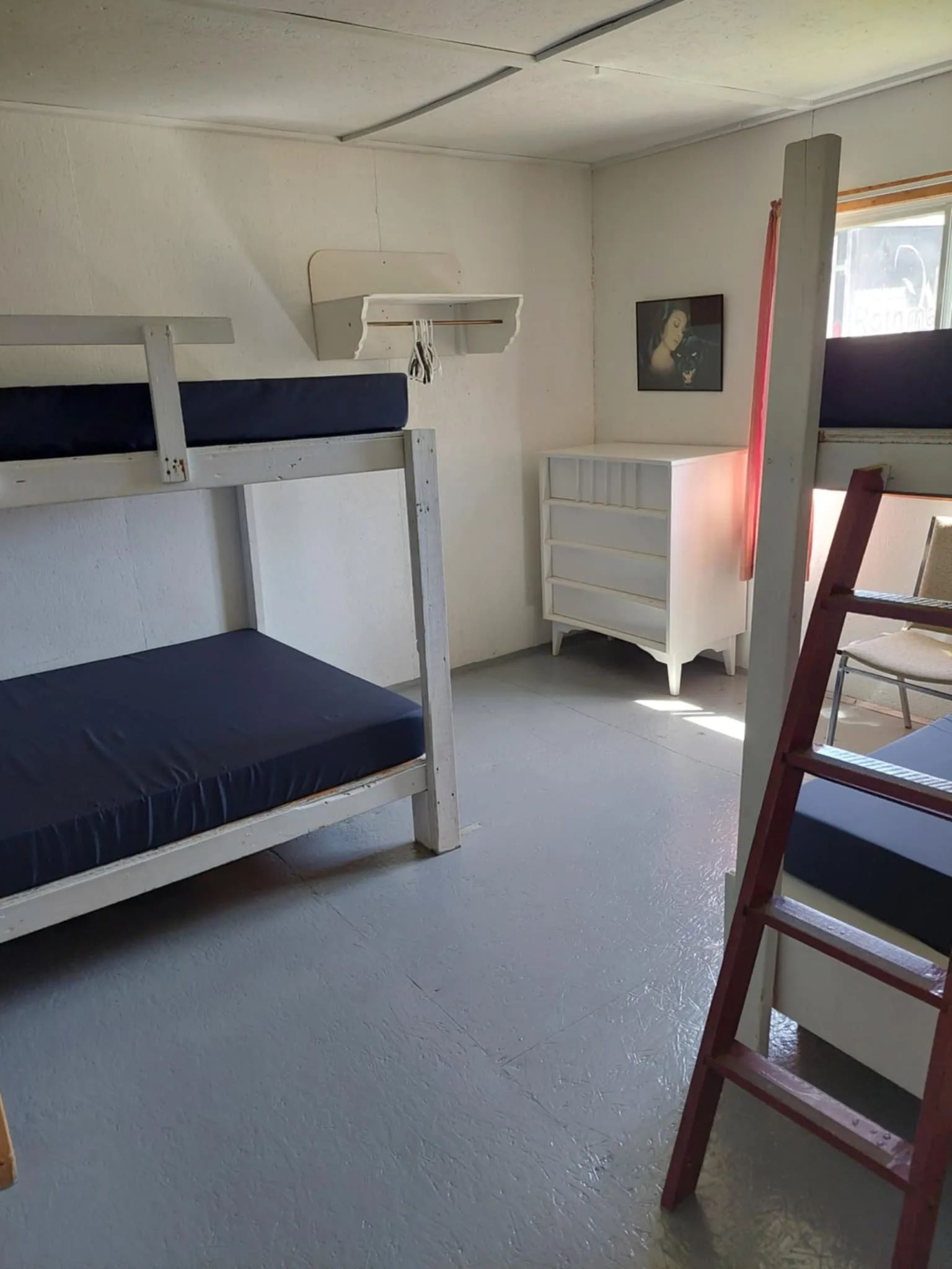 This bedroom at L'Aigle cabin is equipped with bunk beds and a dresser.