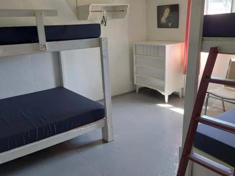 This bedroom at L'Aigle cabin is equipped with bunk beds and a dresser.