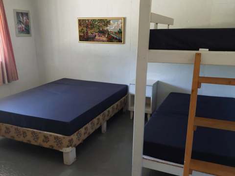 This bedroom at L'Aigle cabin features one single bed and one bunk bed.