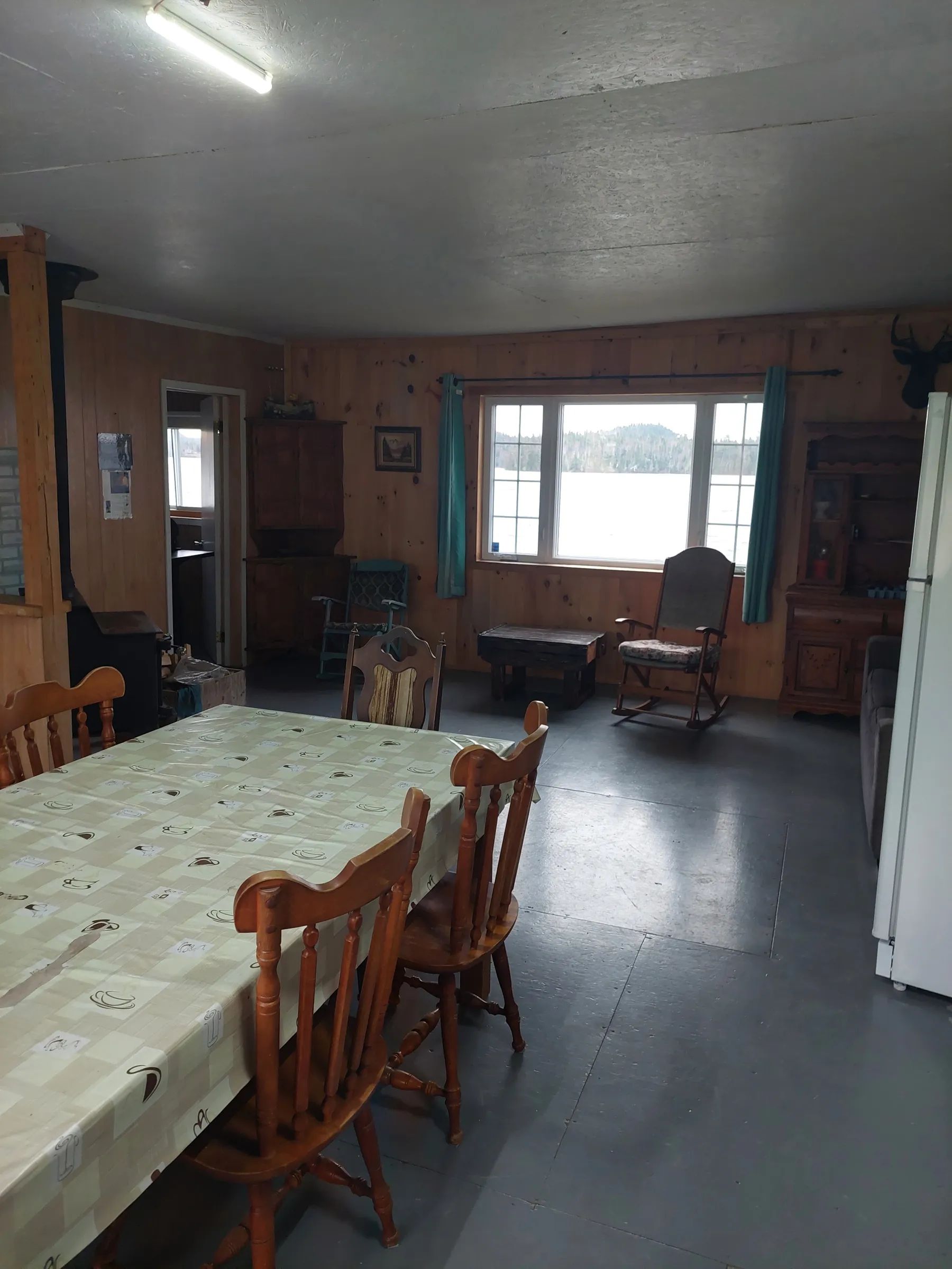 The cottage dining and living area offers a view of the lake.