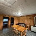View of the chalet 4 dining and living area with its wood-paneled walls.