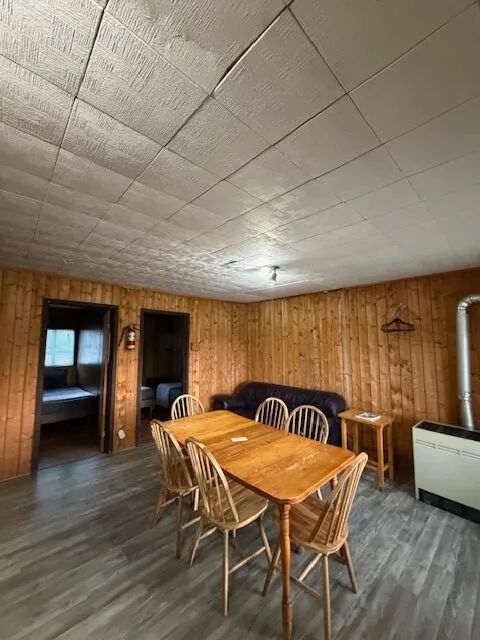 View of the dining room and living area of cottage 4 with wood paneling walls.