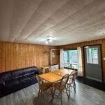 View of the open-plan living and dining area in the cabin.