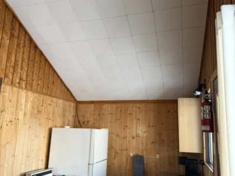The kitchen in cottage 5 includes a stove, a refrigerator, and a sink.