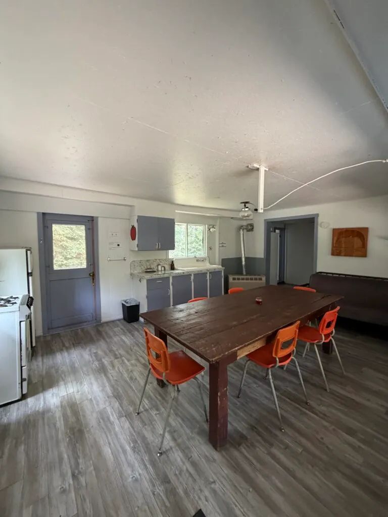 This open area features a functional kitchen and a dining table for your meals.