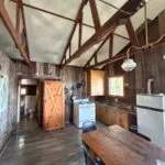 Interior view of the chalet 7 kitchen and dining area with a wooden cathedral ceiling.