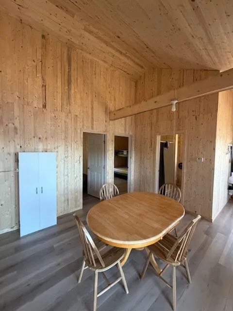 The dining area of chalet 8 featuring natural wood paneling.