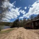 Side view of chalet 8 located near the wooded shoreline.