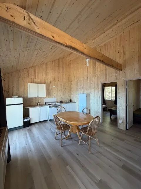 The open kitchen and dining area in chalet 8 provide a bright wooden living space.