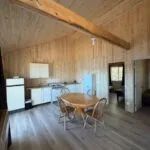 View of the open area including the kitchen, dining room, and access to the cottage bedrooms.