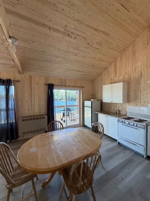 View of the kitchen and dining area in cottage 9 with access to the deck.