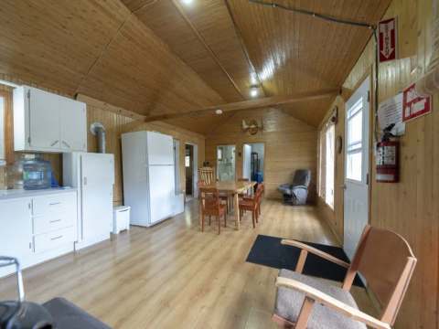 Overview of the open area including the kitchen, dining room, and lounge area of the cottage.