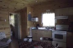 The chalet's kitchen and dining area feature natural wood walls.