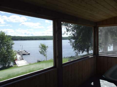 Panoramic view of the lake and dock from the chalet's screened porch.