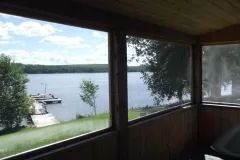 View of the lake and dock from the chalet's screened porch.