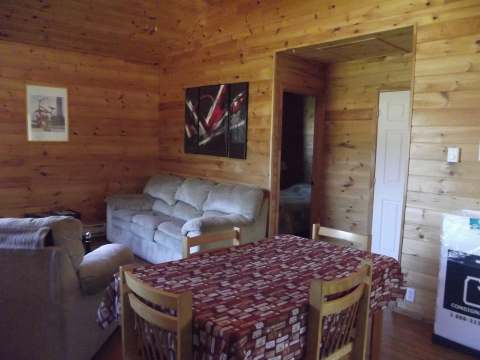 The chalet's dining area and living room provide a warm, all-wood living space.