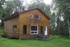 Exterior view of cabin 11 surrounded by the forest.