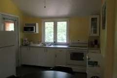 The chalet's equipped kitchen features a stove, a refrigerator, and a microwave.