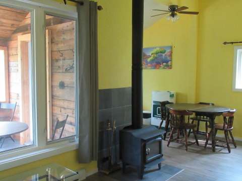 Dining area and wood stove in the cabin's living space.