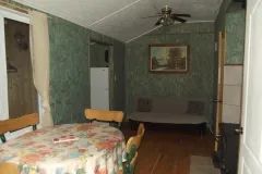 Overview of the cottage's main living area, including the dining table and sofa.