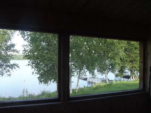 View of the lake and the dock from inside the cabin.