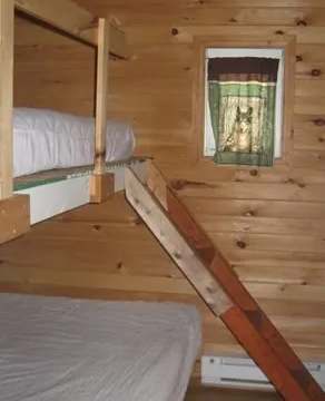 Chalet 3 is equipped with wooden bunk beds with bedding.