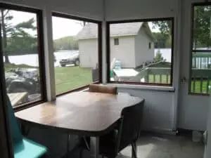 The chalet's veranda offers a view of the lake and its surroundings.