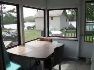 The chalet's veranda offers a view of the lake and its surroundings.