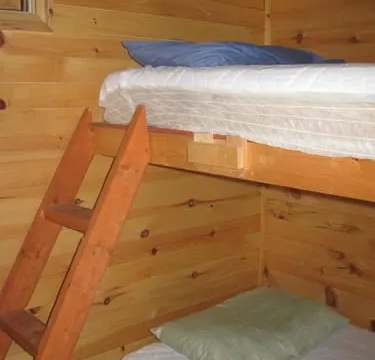 Chalet 2 is equipped with wooden bunk beds with mattresses.