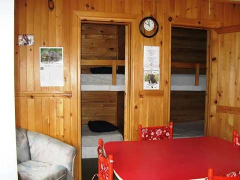 Interior view of the cabin showing bunk beds and a dining table.