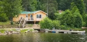View of the cottage with its staircase leading to the dock by the water.