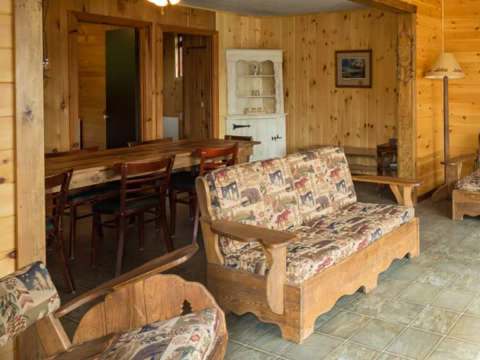 The living and dining area of cottage 6 with its rustic wooden furniture.