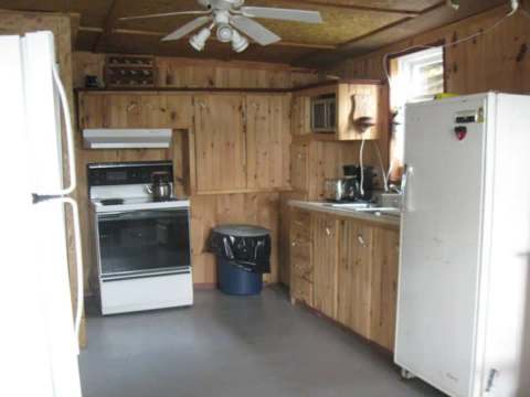 La cuisine fonctionnelle du chalet est équipée d'une cuisinière, d'un réfrigérateur et de rangement.