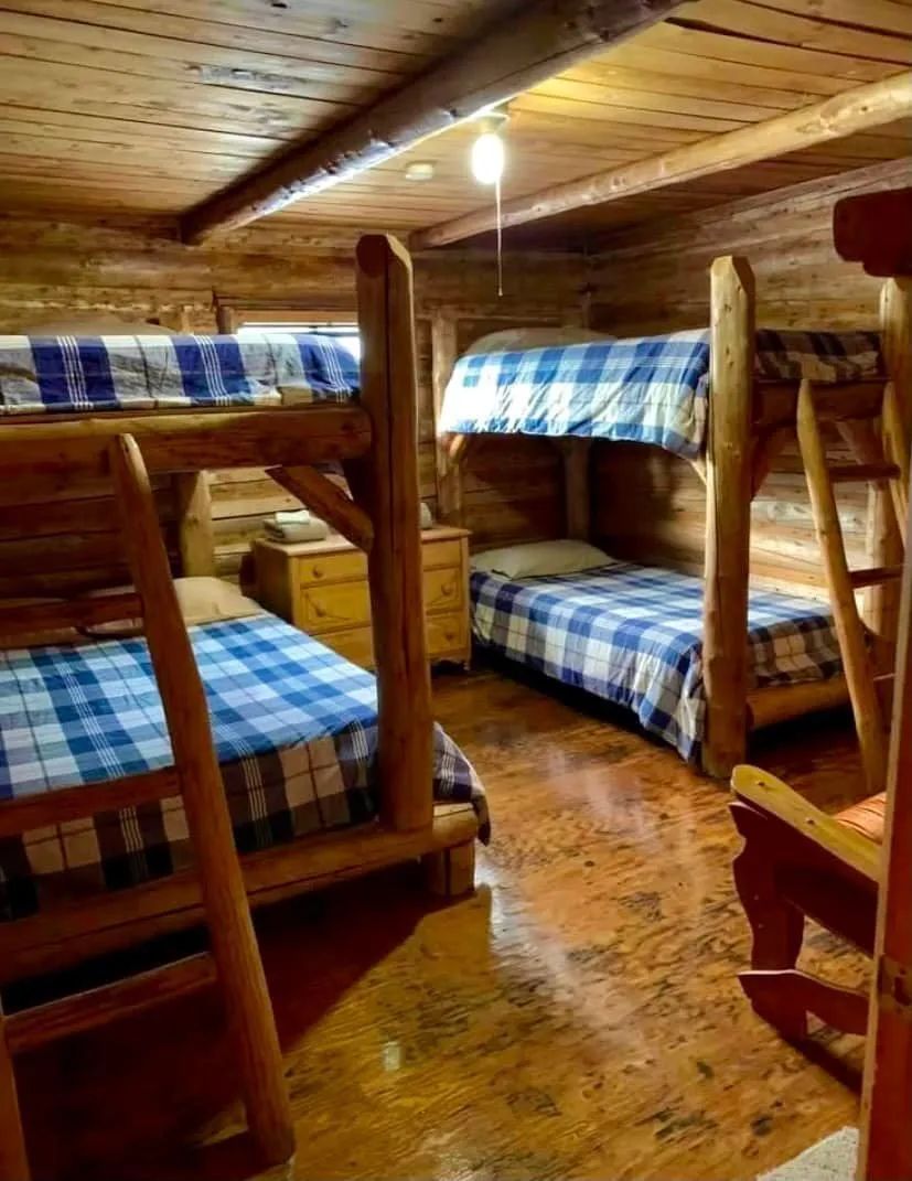 This rustic bedroom is equipped with two wooden bunk beds.