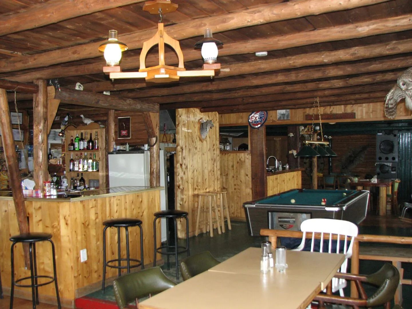 The lodge's bar and game area includes a counter, tables, and a pool table.