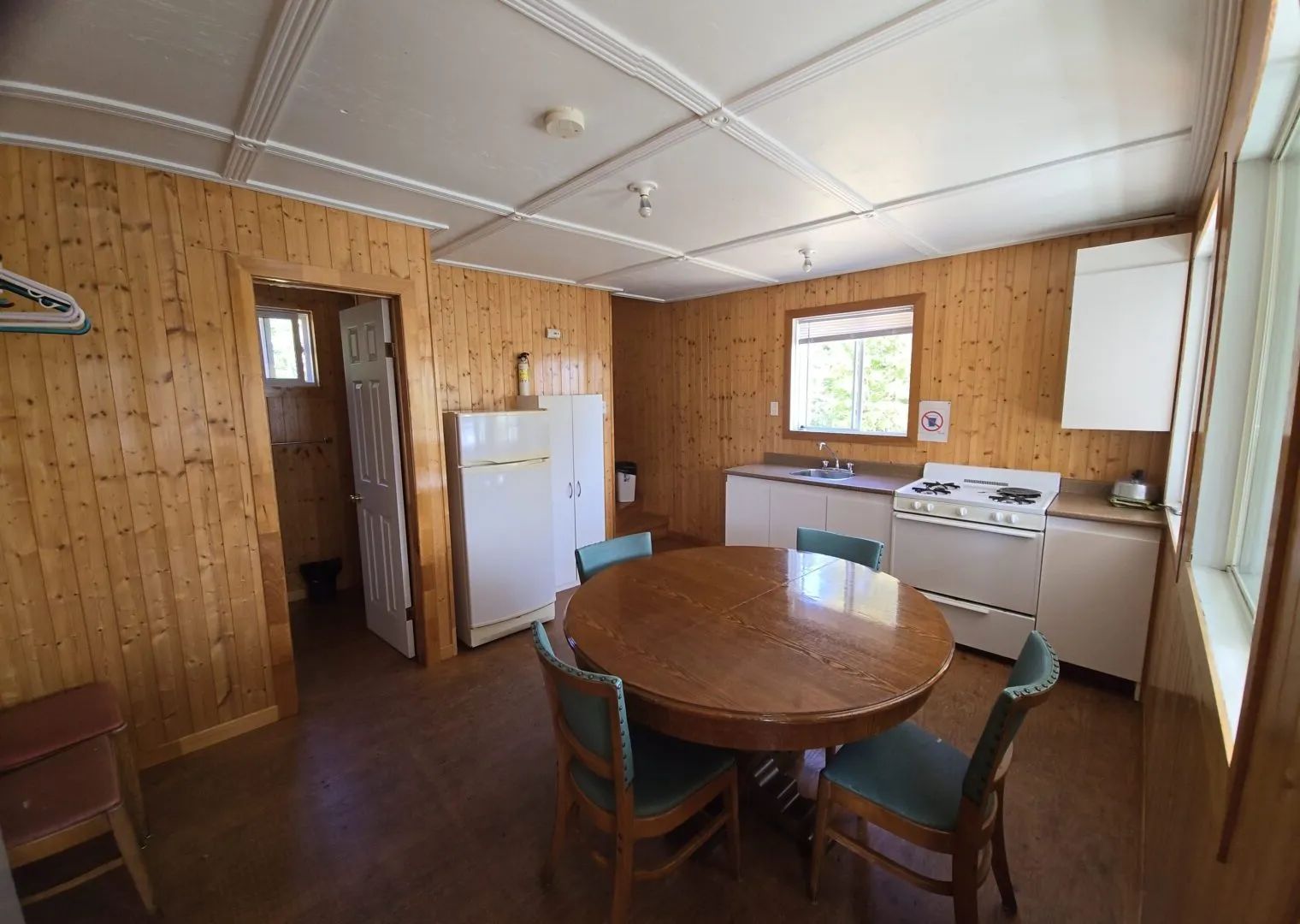 The cabin's functional kitchen features a dining table and the necessary appliances.