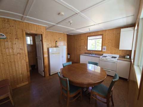 The cabin's functional kitchen features a dining table and the necessary appliances.